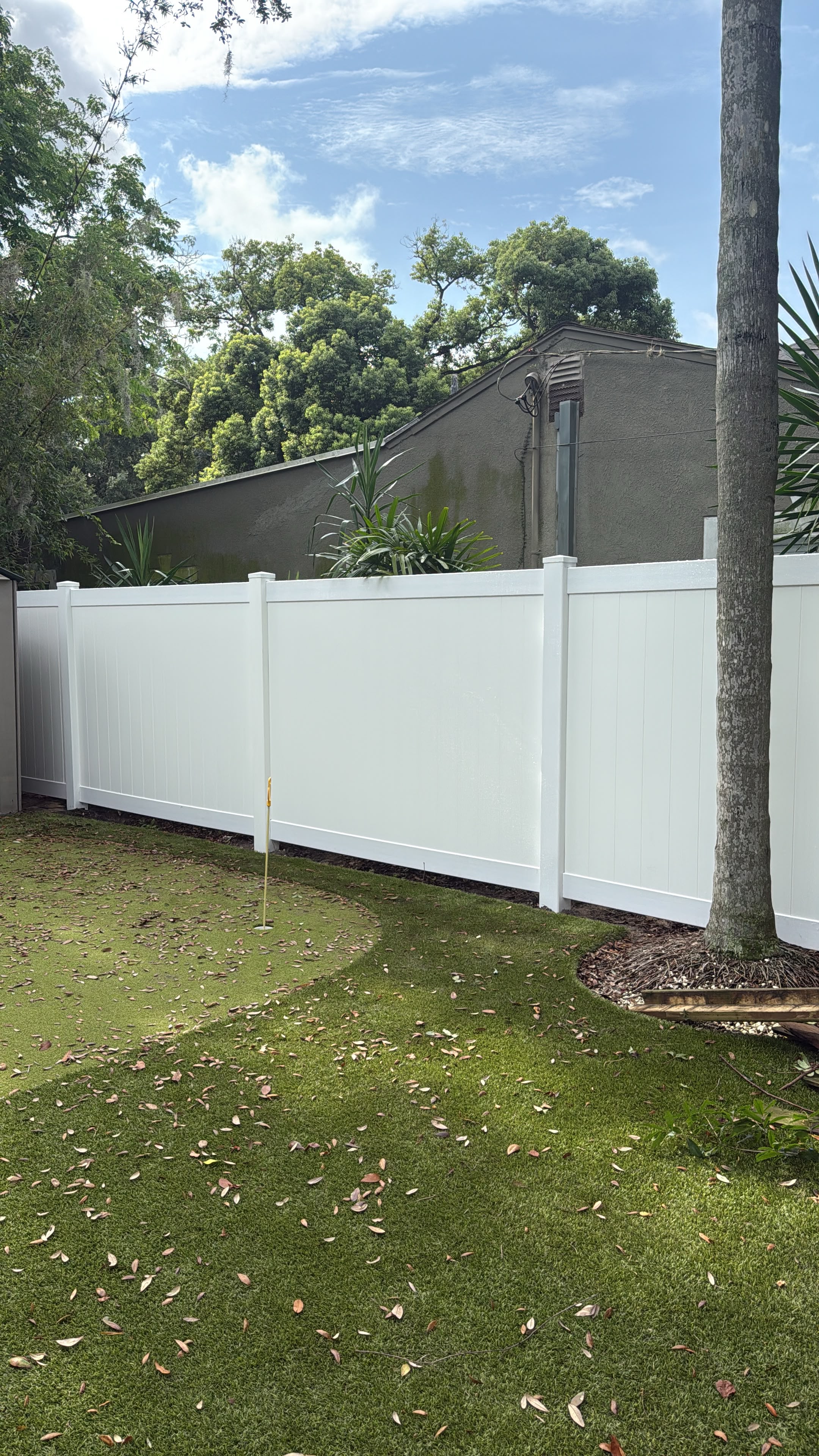 Completed white PVC fence installation
